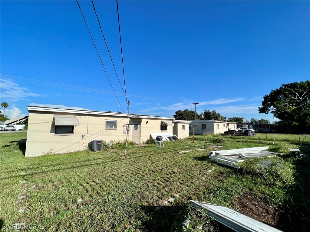 24 Alabama Road South Lehigh Acres, FL 33936 - Photo 15 of 17 a view of a house with a yard