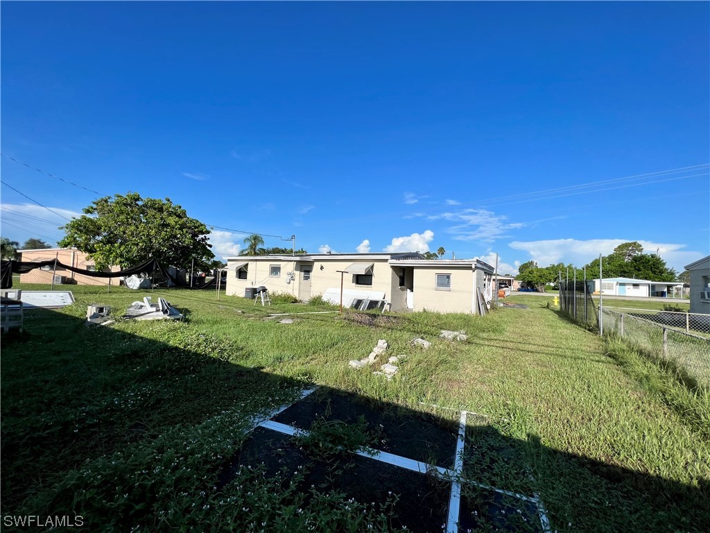 24 Alabama Road South Lehigh Acres, FL 33936 - Photo 16 of 17 a view of a house with a yard