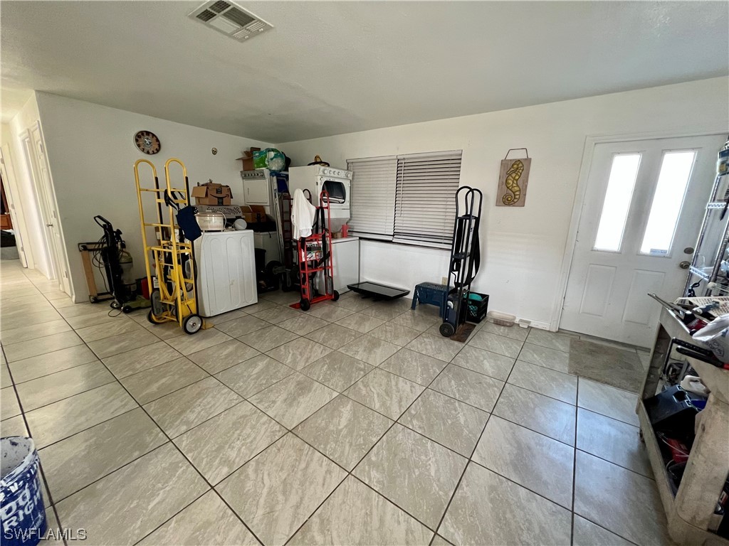 24 Alabama Road South Lehigh Acres, FL 33936 - Photo 3 of 17 a view of a room with gym equipment