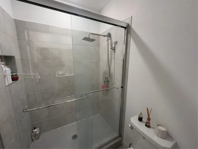 a view of walk in closet with clothes