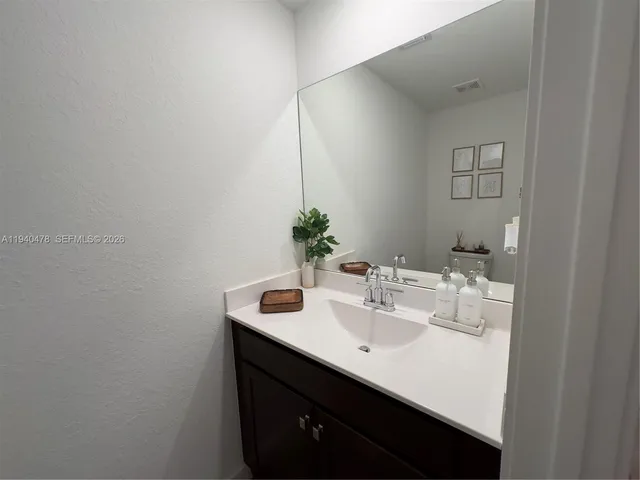 a bathroom with a sink a toilet and vanity