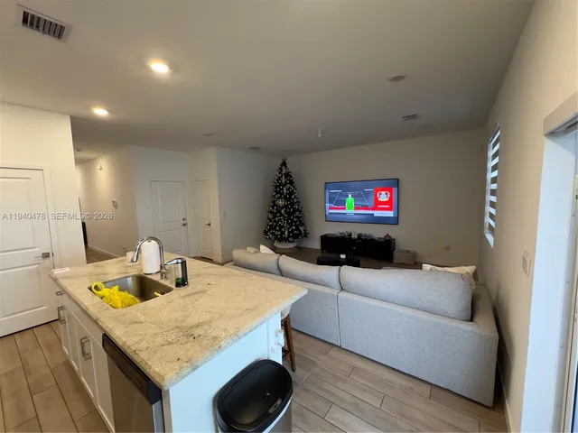 a kitchen with a refrigerator and a stove top oven