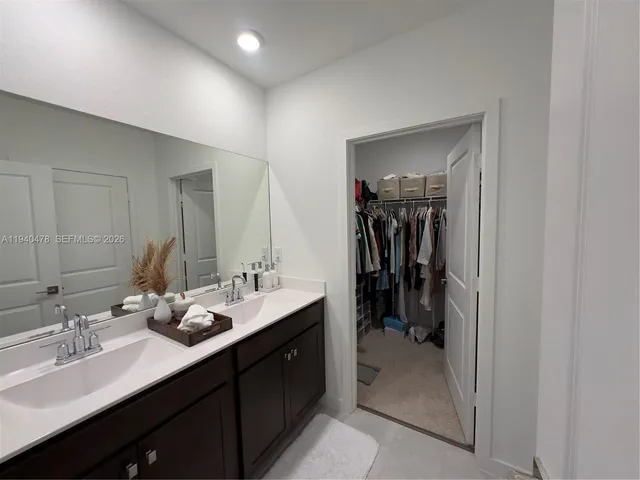 a kitchen with a stove and white cabinets