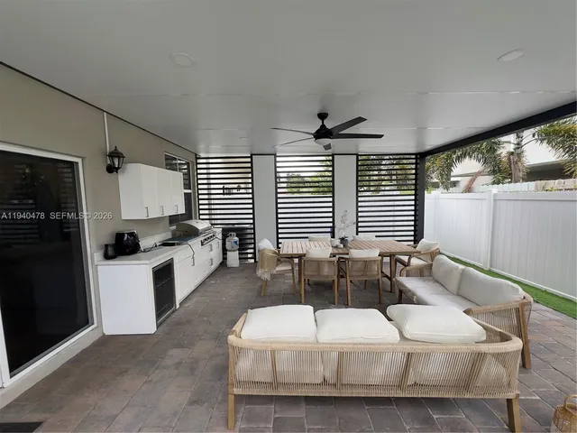 a living room with furniture potted plant and a chandelier