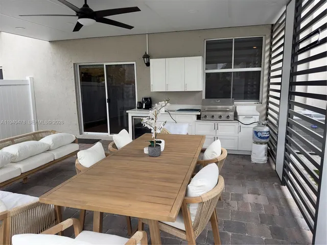 a living room with furniture a table and chairs next to a window
