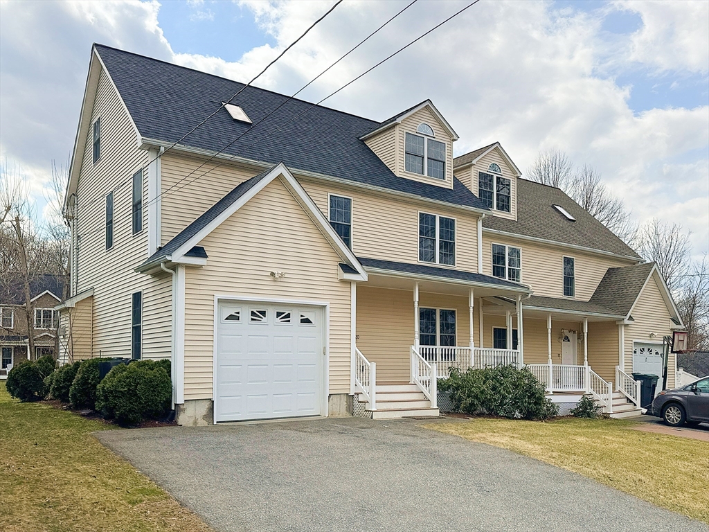 a view of a white house next to a yard