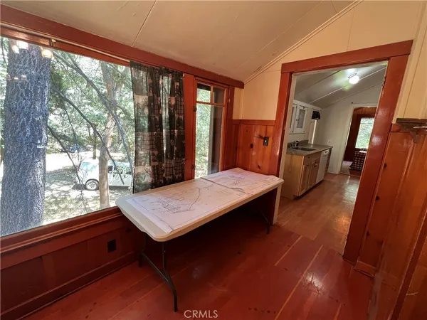 a room with pool table and wooden floor