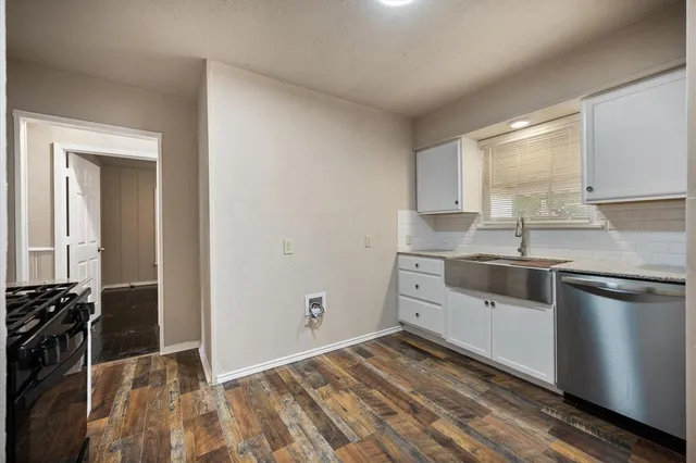 a kitchen with a sink stove and cabinets