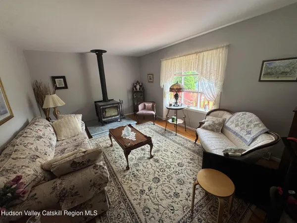 a living room with furniture and a floor to ceiling window