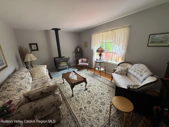 a living room with furniture and a floor to ceiling window