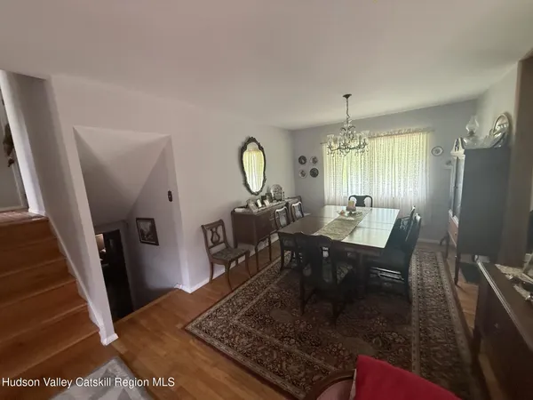 a dining room with furniture a rug and a chandelier