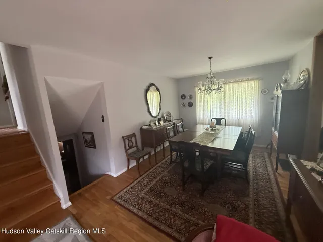a dining room with furniture a rug and a chandelier