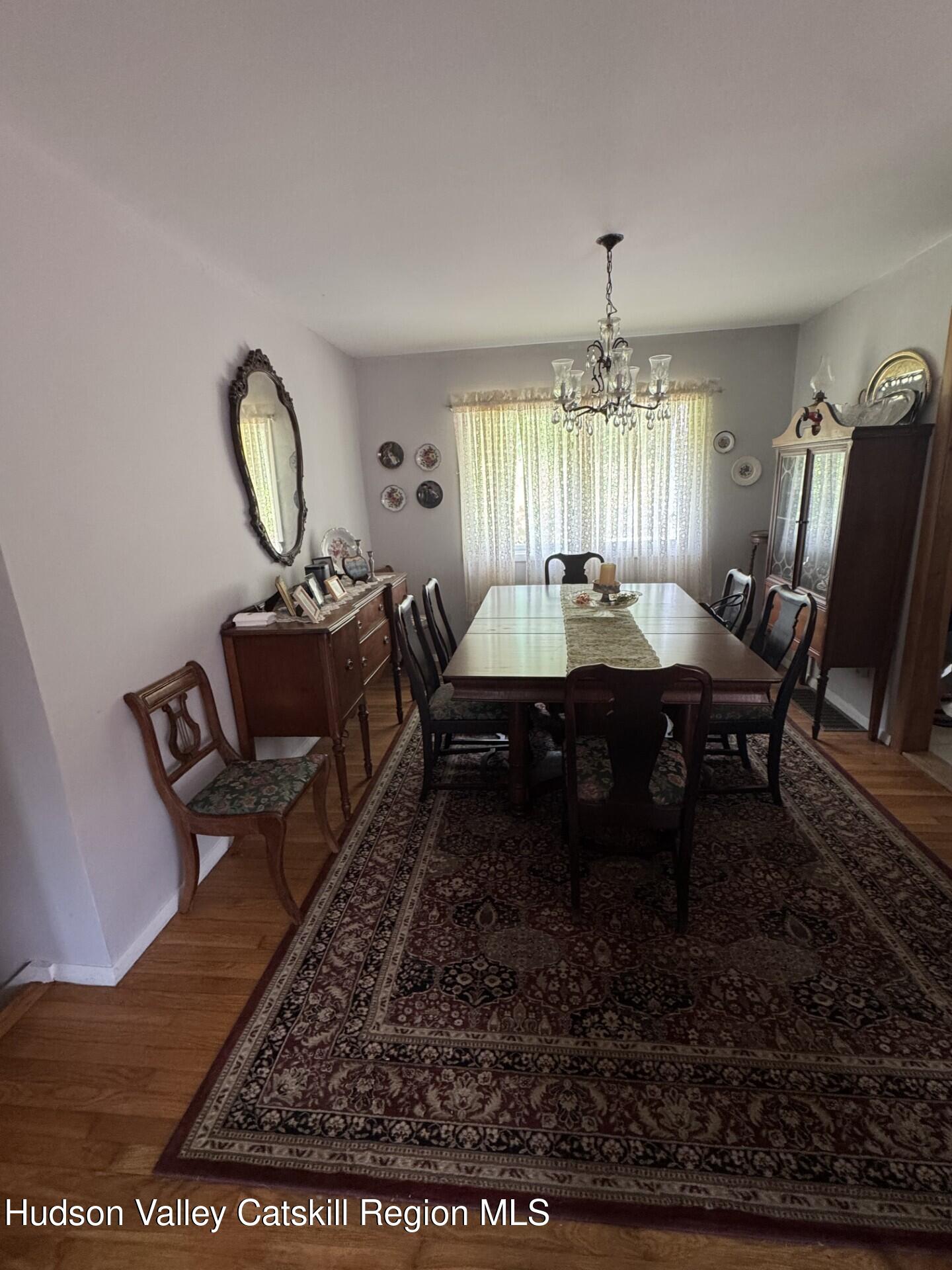 20 Slater Road Windham, NY 12454 - Photo 14 of 47 a dining room with furniture a rug and a chandelier