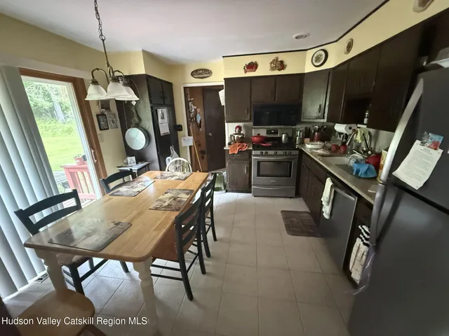 a view of a dining room with furniture and window