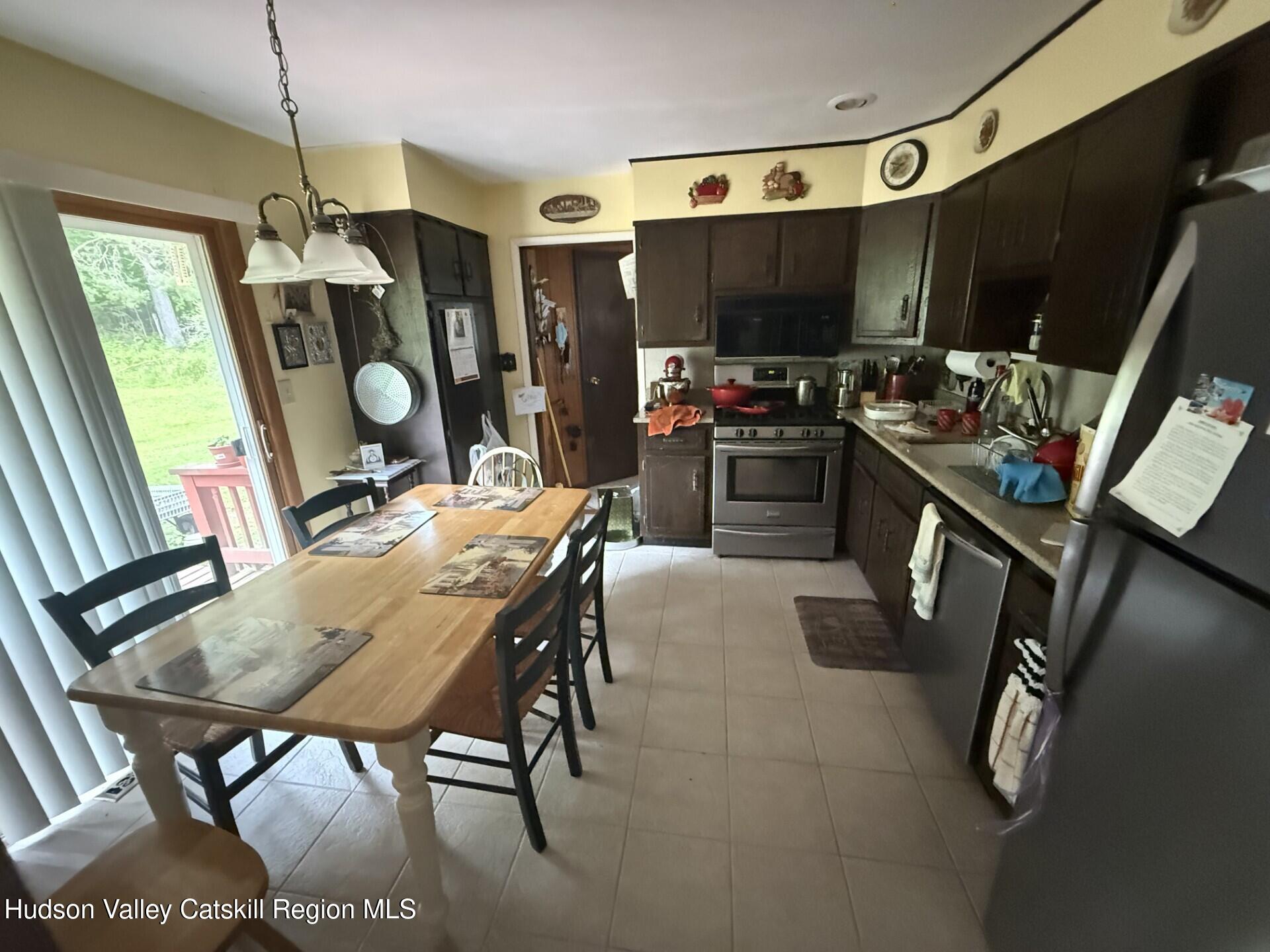 20 Slater Road Windham, NY 12454 - Photo 17 of 47 a view of a dining room with furniture window and wooden floor