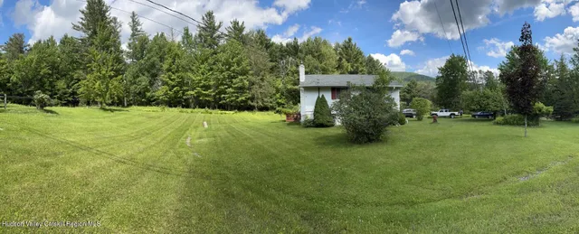 a view of outdoor space with deck and yard