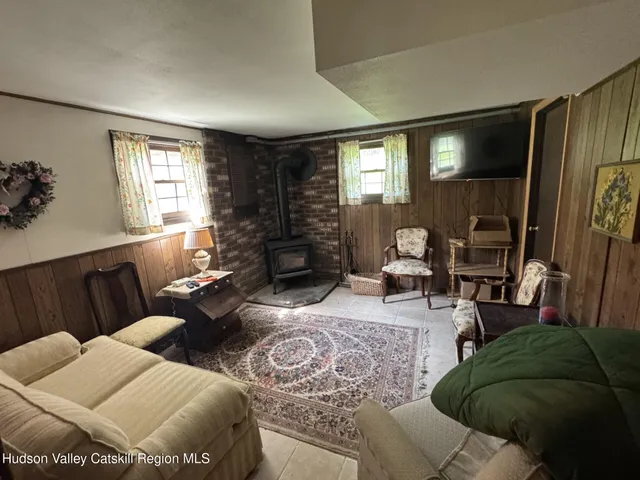 a view of water heater room with wooden floor