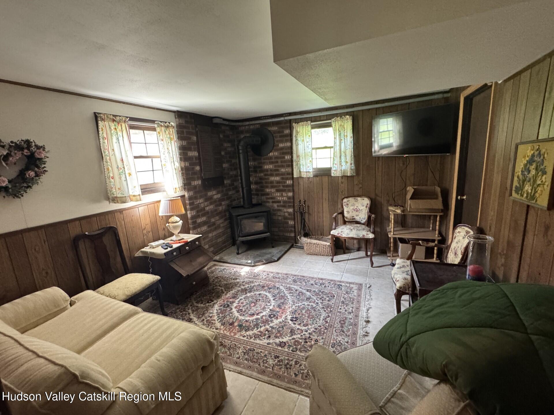 20 Slater Road Windham, NY 12454 - Photo 26 of 47 a living room with furniture and a window