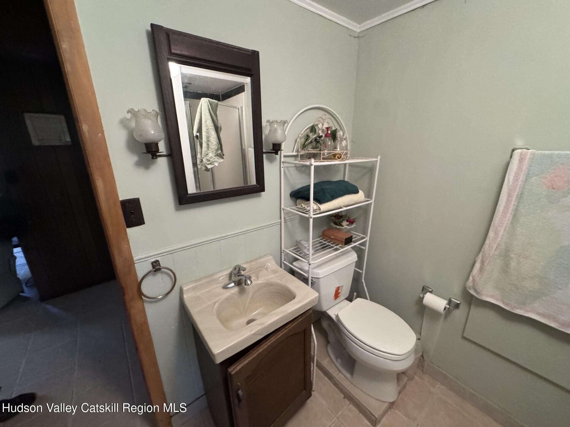 20 Slater Road Windham, NY 12454 - Photo 29 of 47 a bathroom with a toilet sink and mirror