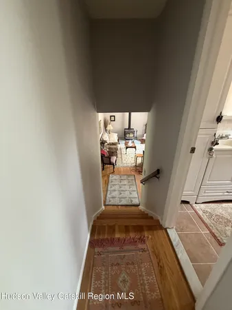 a bedroom with a bed and a dresser next to a window