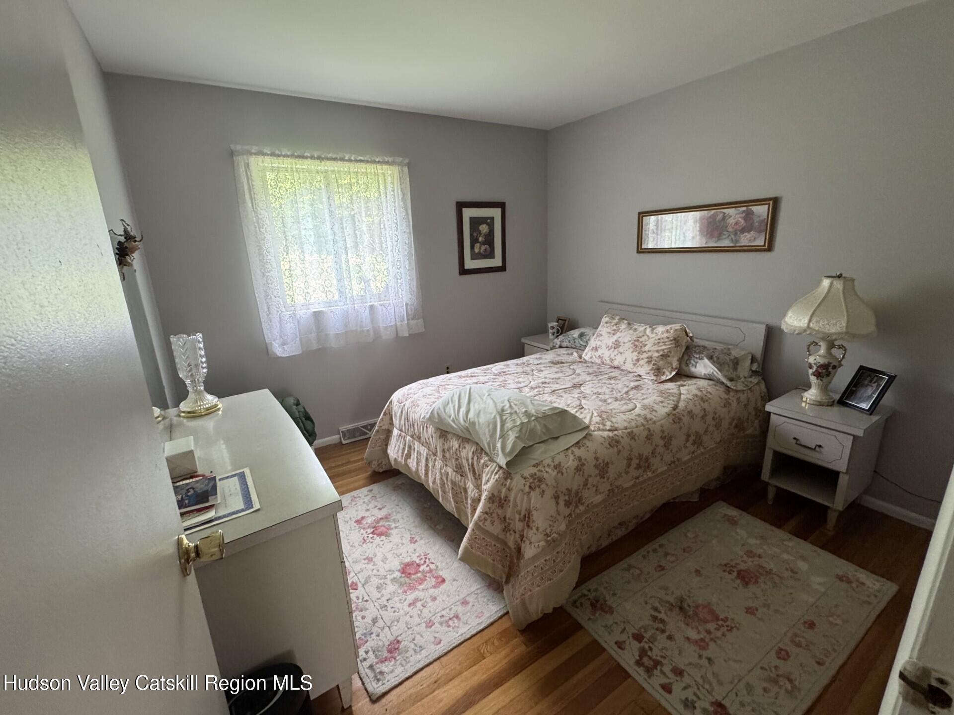 20 Slater Road Windham, NY 12454 - Photo 34 of 47 a bedroom with a bed and wooden floor