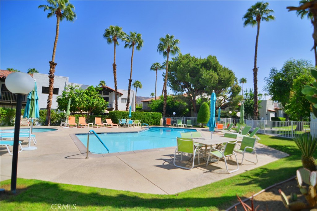 250 East San Jose Road, Unit 63 Palm Springs, CA 92264 - Photo 12 of 22 a view of a swimming pool with a table and chairs