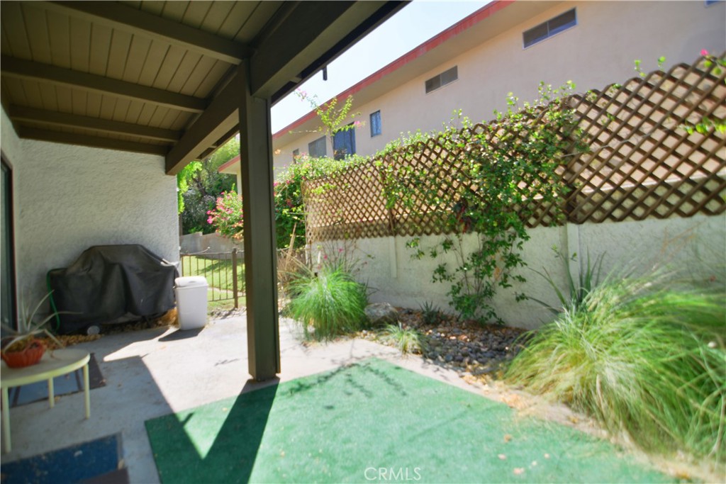250 East San Jose Road, Unit 63 Palm Springs, CA 92264 - Photo 21 of 22 a backyard of a house with table and chairs