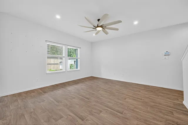 wooden floor in an empty room with a window