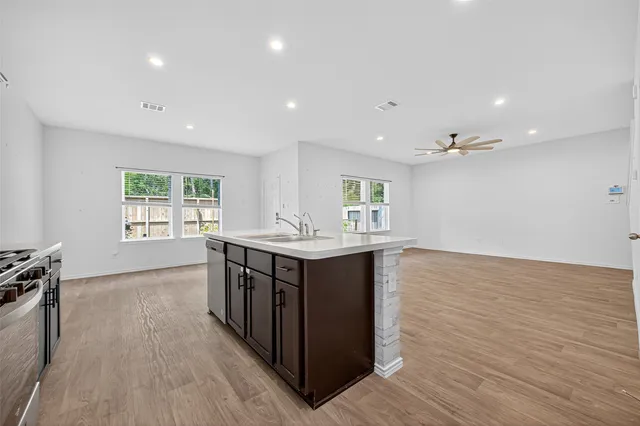 a view of kitchen with wooden floor electronic appliances and window