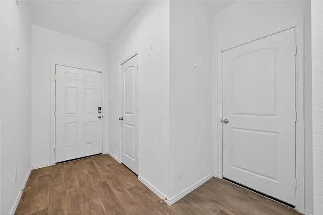 a view of a room with wooden floor
