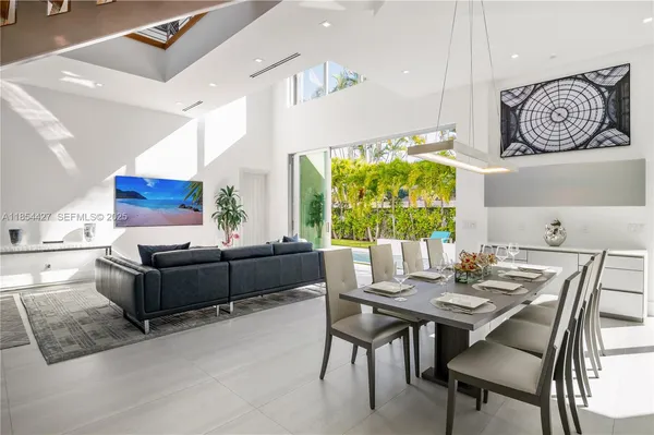 a kitchen with a table chairs sink and cabinets