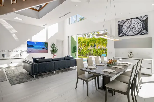 a kitchen with a sink and chairs