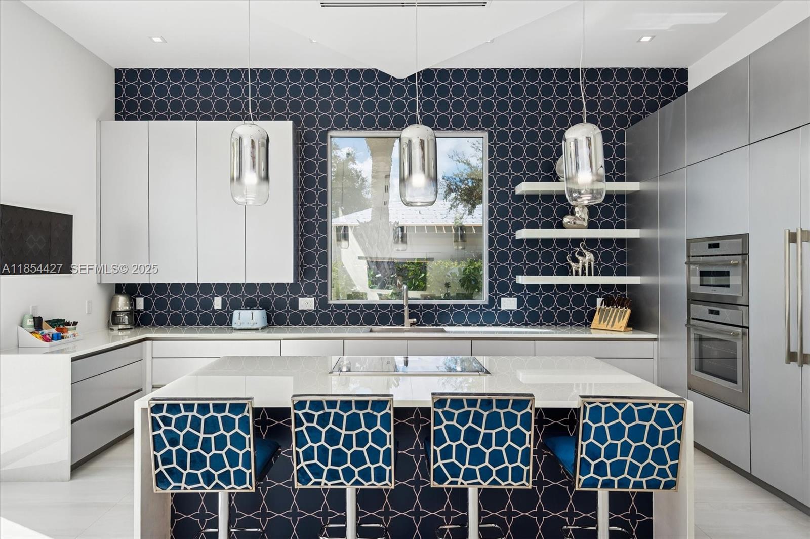 2628 Marcinski Road Jupiter, FL 33477 - Photo 16 of 70 a kitchen with a wooden floor and cabinets