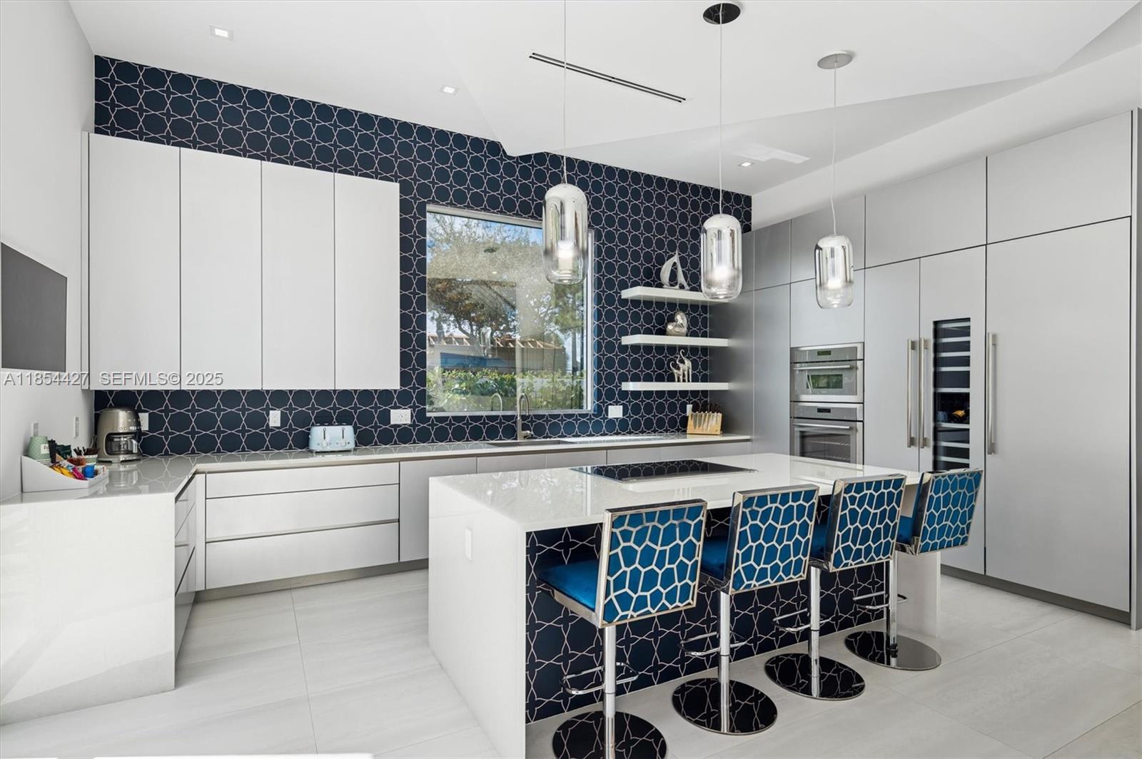 2628 Marcinski Road Jupiter, FL 33477 - Photo 17 of 70 a kitchen with a table chairs sink and cabinets