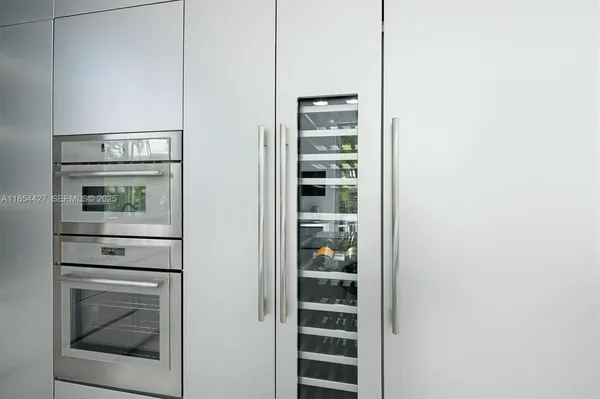 a large kitchen with a large window and stainless steel appliances
