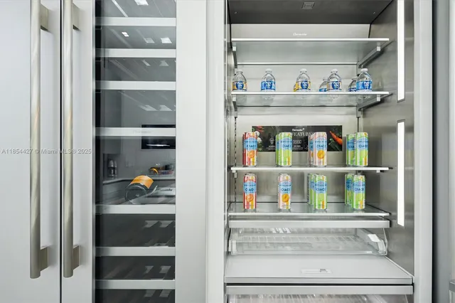 a large kitchen with a large window and stainless steel appliances