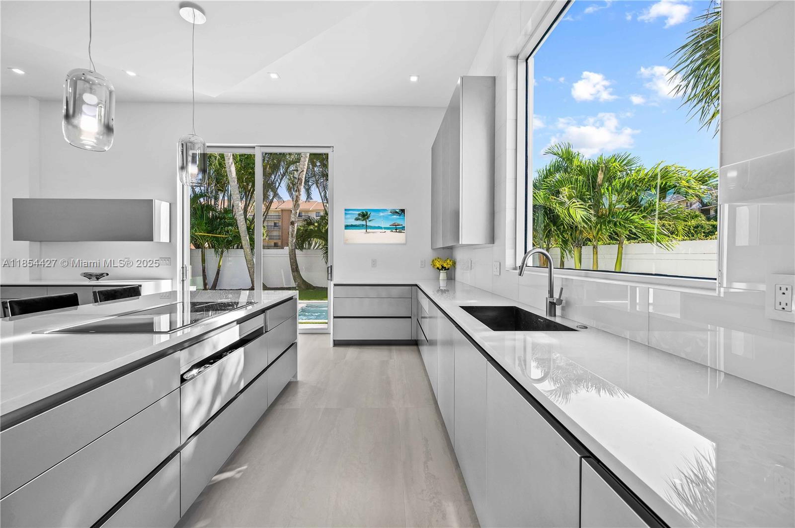 2628 Marcinski Road Jupiter, FL 33477 - Photo 25 of 70 a large kitchen with a large window and stainless steel appliances