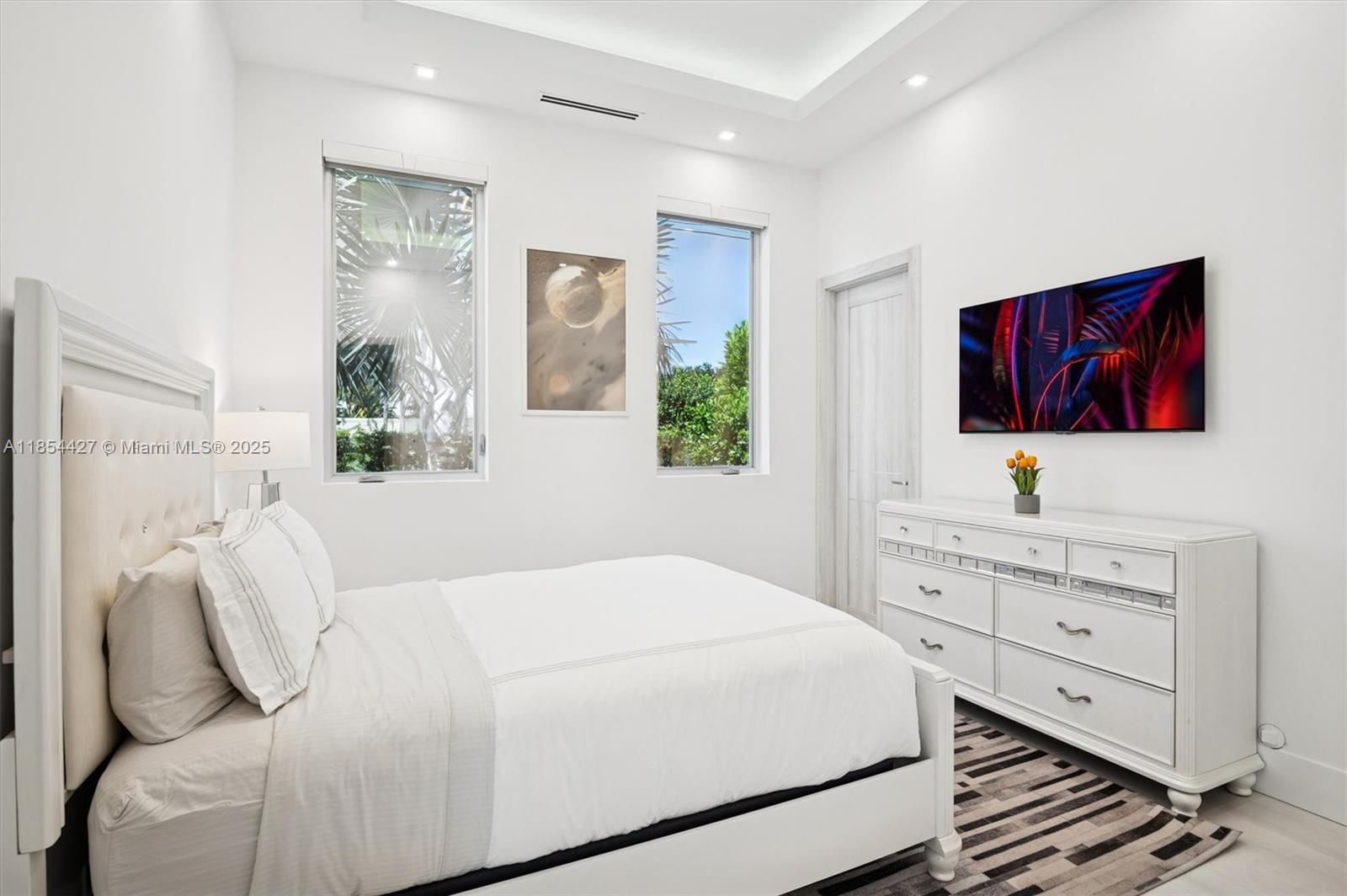 2628 Marcinski Road Jupiter, FL 33477 - Photo 45 of 70 a bedroom with a bed and a flat screen tv