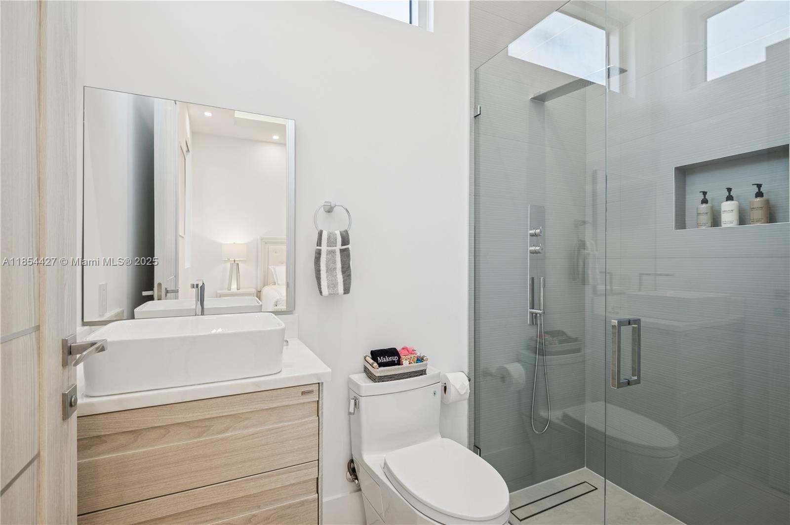 2628 Marcinski Road Jupiter, FL 33477 - Photo 50 of 70 a bathroom with a sink a toilet and shower