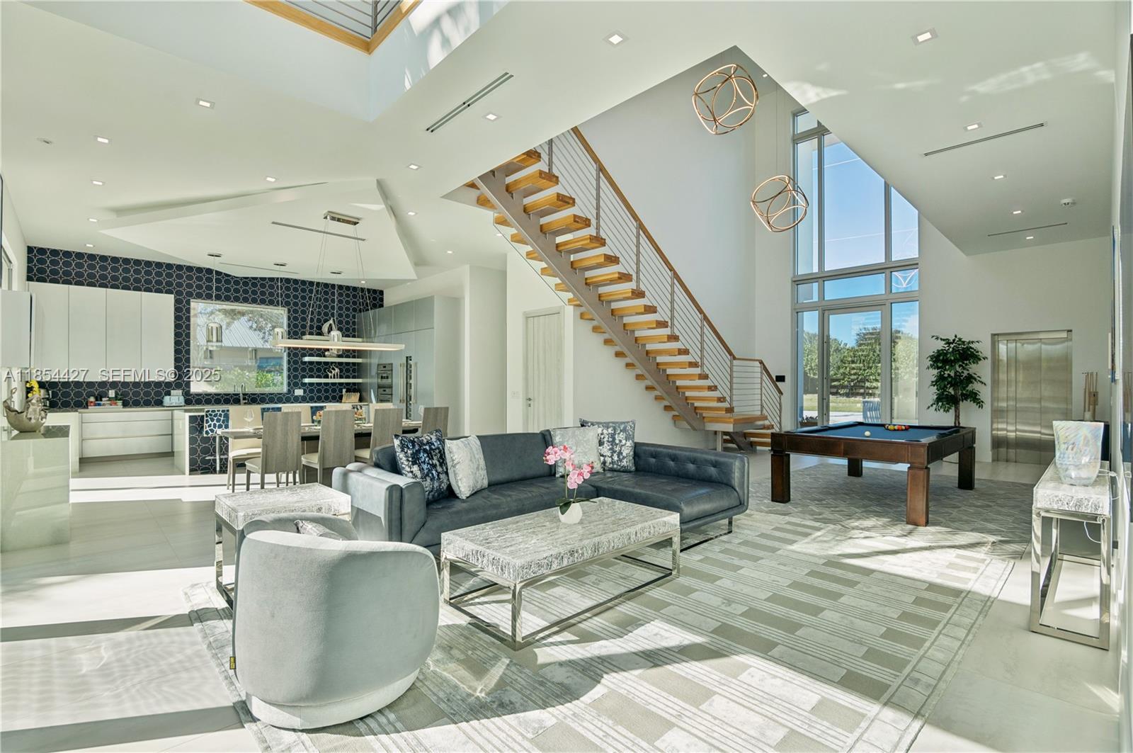 2628 Marcinski Road Jupiter, FL 33477 - Photo 6 of 70 a living room with furniture and a table