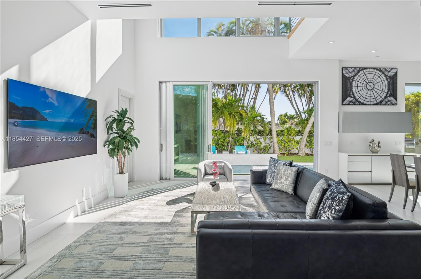 2628 Marcinski Road Jupiter, FL 33477 - Photo 9 of 70 a living room with furniture and a large window