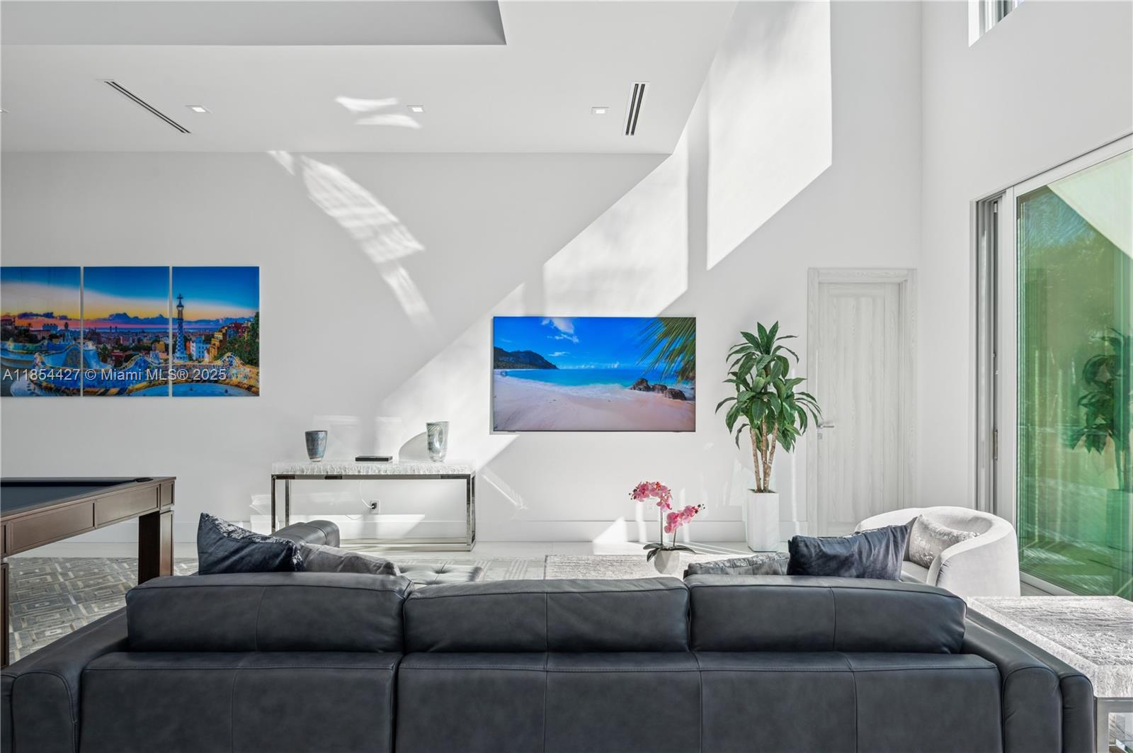 2628 Marcinski Road Jupiter, FL 33477 - Photo 10 of 70 a living room with furniture and a potted plant