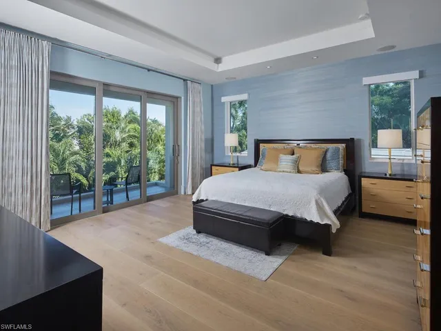 a bedroom with a bed and large window