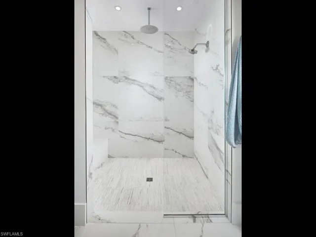 a bathroom with a glass shower door