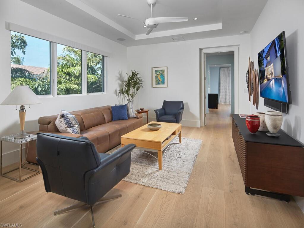 355 7th Avenue South Naples, FL 34102 - Photo 20 of 37 a living room with furniture and a flat screen tv