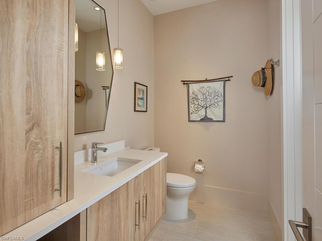 355 7th Avenue South Naples, FL 34102 - Photo 26 of 37 a bathroom with a toilet sink and mirror
