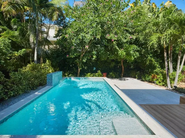 a view of a backyard with large trees