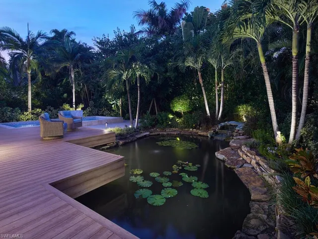 a view of a backyard with swimming pool