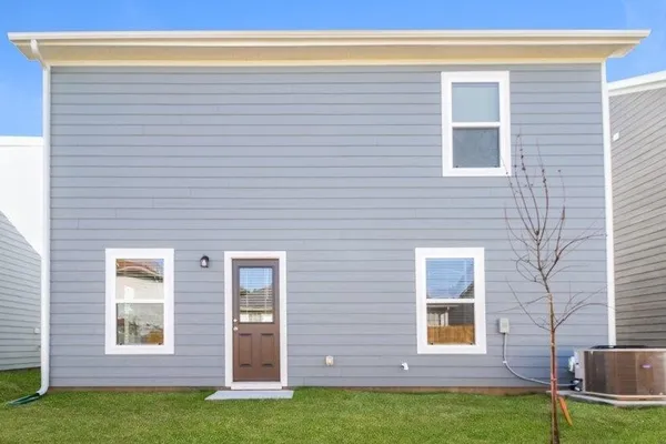 a view of a house with a backyard