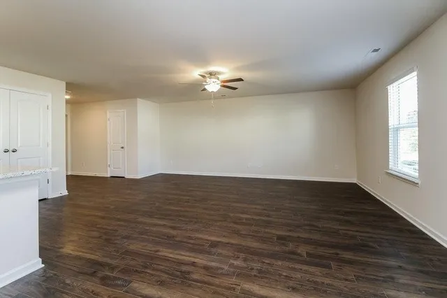 wooden floor in an empty room with a window
